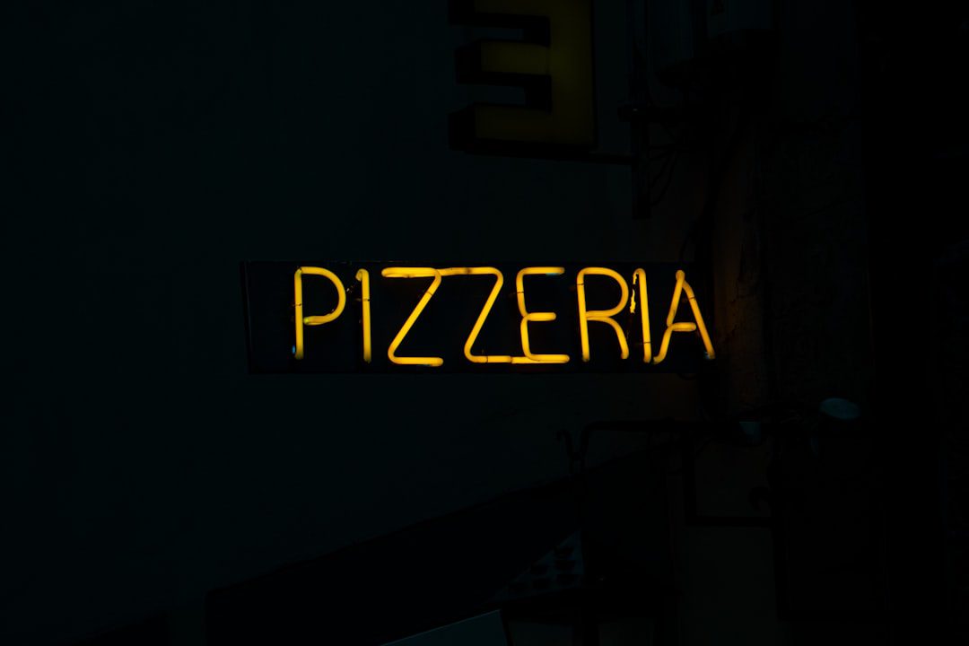 a neon sign that reads pizzeria on it